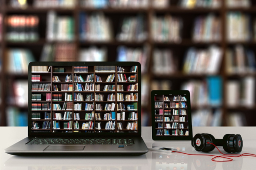 Laptop and tablet with ebooks bookshelves behind